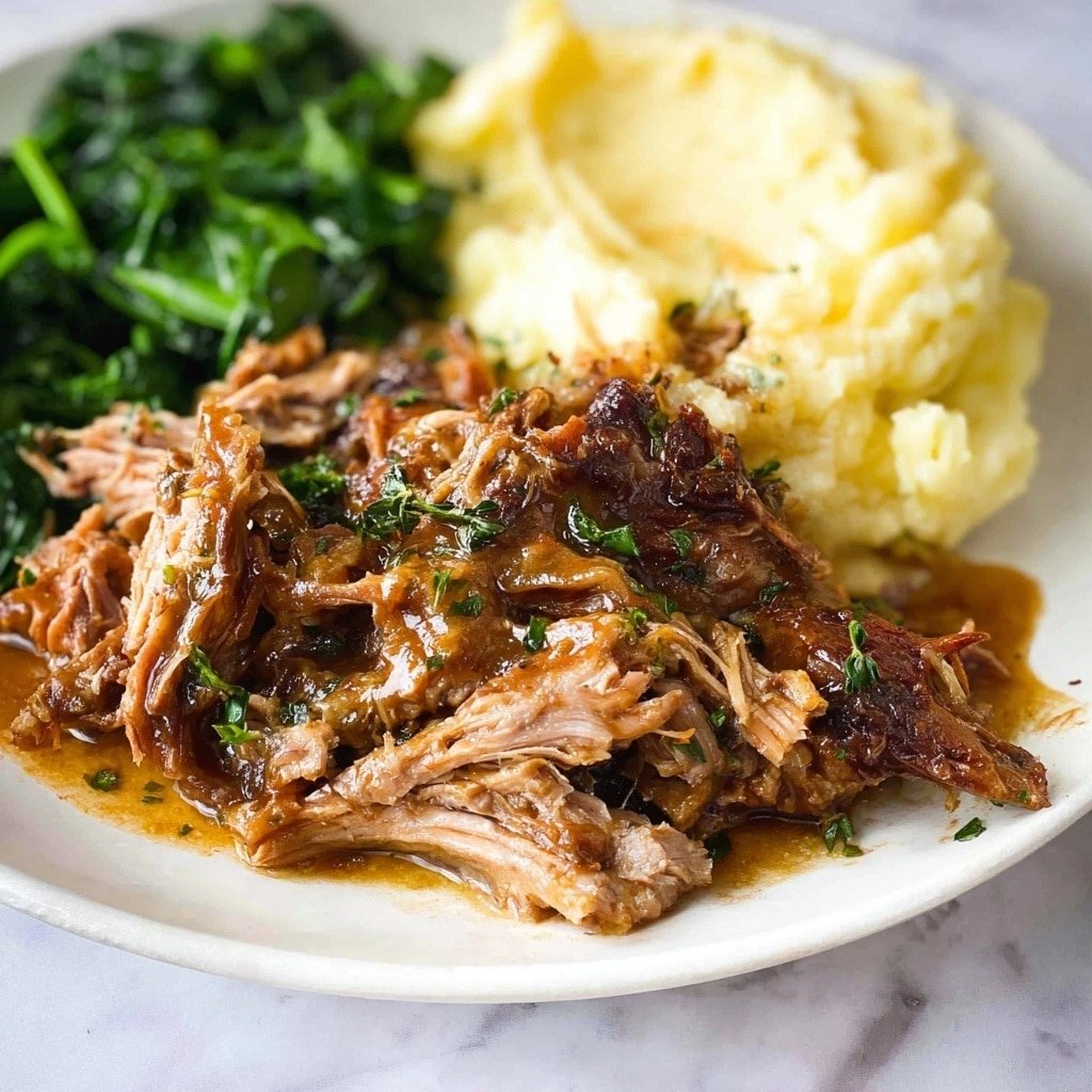 The image shows a white plate on a white marbled surface with three main parts: shredded meat covered in brown sauce, mashed potatoes that look soft and creamy, and cooked green leafy vegetables that are placed behind the meat and potatoes. The shredded meat has a mix of light and dark brown colors with a moist texture, with some green herb pieces sprinkled on top. The mashed potatoes are pale yellow and smooth, sitting in the top right part of the plate. The green vegetables appear fresh and slightly shiny, placed at the upper left part of the plate. Photo taken with an iphone --ar 4:5 --v 7